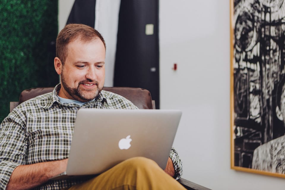 Person using KiwiBooks dashboard on laptop